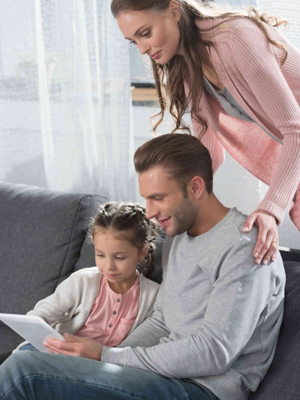 young-family-with-little-daughter-sitting-on-couch-2023-11-27-04-53-12-utc (1)